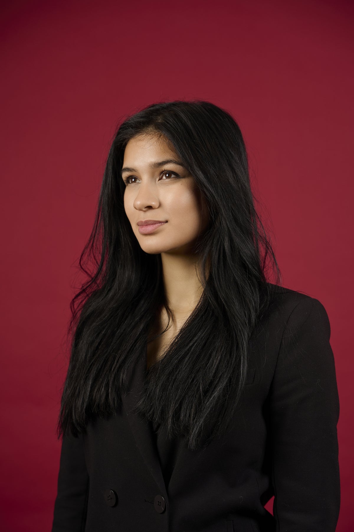 Jane Yanie Lienhard Lienhard VIII Woman wearing a black blazer against a red background
