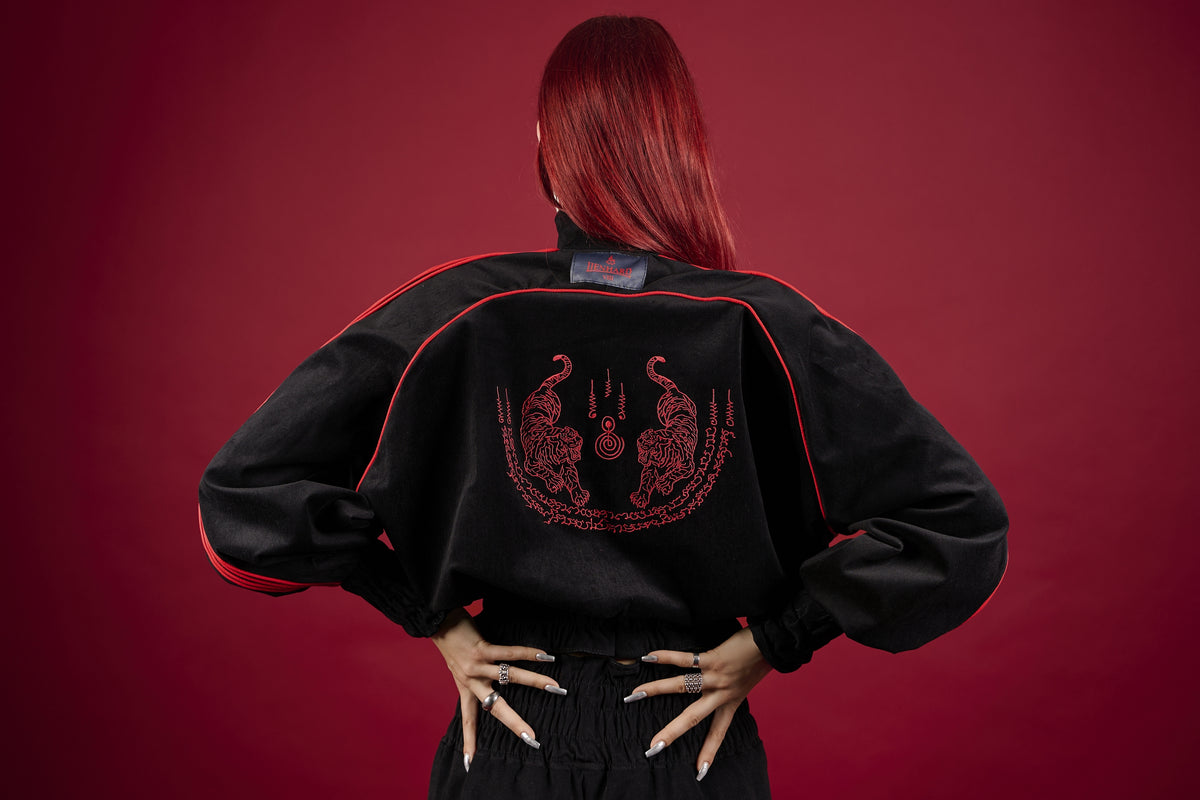 Person wearing a black jacket with red embroidery on a red background Muay Thai Streetwear Sak Yant Tattoo Thai Boxing Tracksuit Muay Thai Cropped Jacket